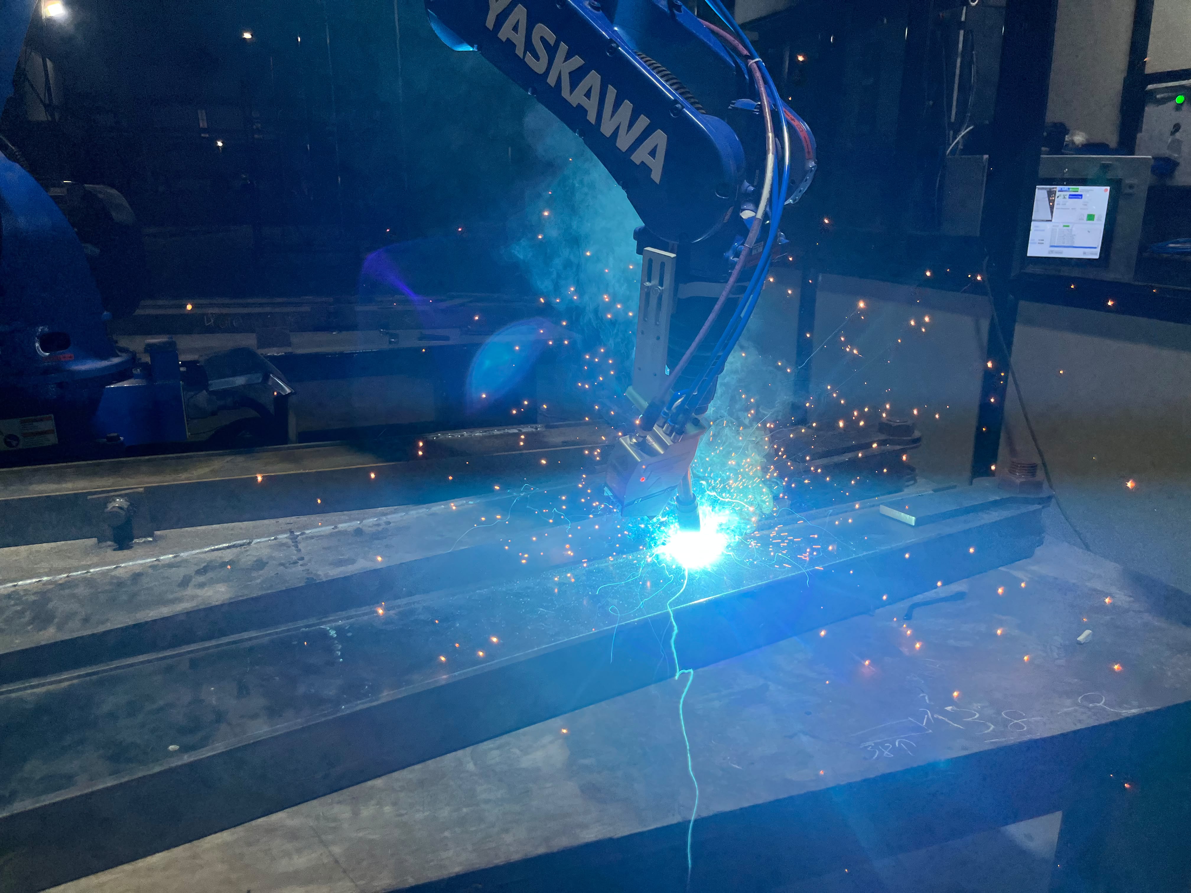 Yaskawa industrial robot welding a steel assembly